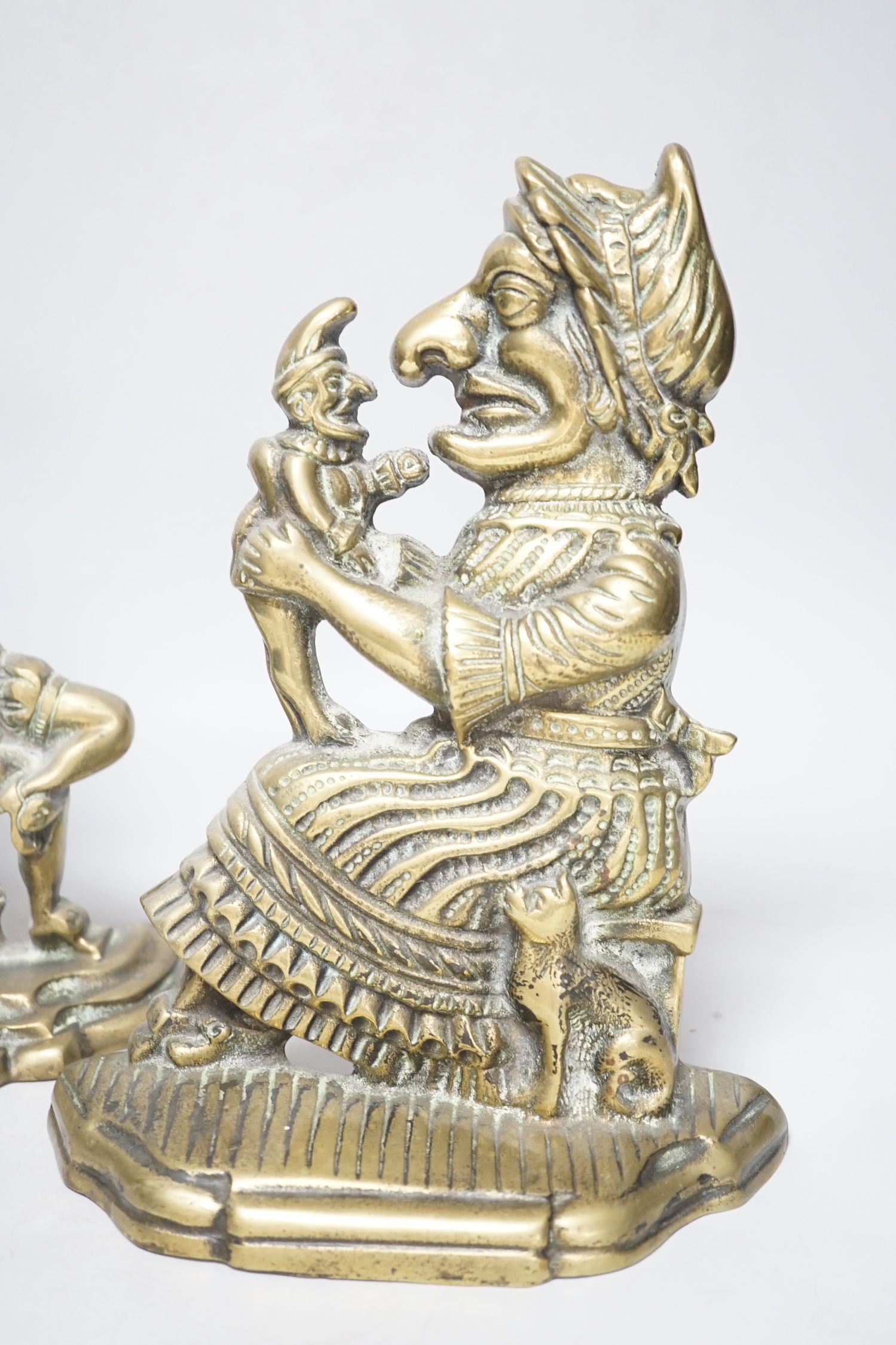A pair of cast brass Punch and Judy door-stops, the largest 28cm high